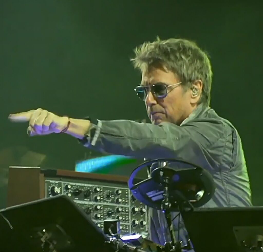 From Oxygène to the Metaverse: The Enduring Vision of Jean-Michel Jarre
Jean-Michel Jarre, born on August 24, 1948, in Lyon, France, is a pioneering figure in electronic, ambient, and new-age music. The son of renowned film composer Maurice Jarre, Jean-Michel carved his own path, becoming known for his groundbreaking work in electronic music and his spectacular outdoor concerts featuring vast laser displays and fireworks.